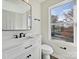 Bright bathroom with a modern vanity, sleek fixtures, and a large window providing natural light and outside views at 3201 Decapolis Dr, Charlotte, NC 28215