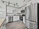 Contemporary kitchen featuring stainless steel appliances, granite countertops, and sleek white cabinets with modern hardware at 3201 Decapolis Dr, Charlotte, NC 28215