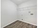 Laundry room with vinyl floors, bright white walls, wire shelving, and hookups for washer and dryer at 3201 Decapolis Dr, Charlotte, NC 28215