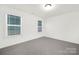 Empty bedroom with carpet, base trim, and a well lit window at 32586 Millingport Rd # 7147, New London, NC 28127