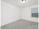 Bright bedroom with plush gray carpeting and a window with wood blinds at 32586 Millingport Rd # 7147, New London, NC 28127
