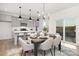 Dining area and kitchen featuring gray cabinets, pendant lights, and a view to the backyard at 32586 Millingport Rd # 7147, New London, NC 28127