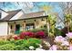 Charming home with a cozy front porch framed by colorful flowers and landscaping at 3707 Banyon Nw Ct, Concord, NC 28027