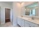 Bathroom featuring double vanity sinks with white cabinets, tile floors, and a glass enclosed shower at 3886 Horsham St, Indian Land, SC 29707