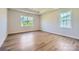 Spacious bedroom with tray ceiling, hardwood floors, and large windows overlooking the yard at 3886 Horsham St, Indian Land, SC 29707