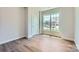 Comfortable bedroom with hardwood floors and a window providing natural light and outdoor views at 3886 Horsham St, Indian Land, SC 29707