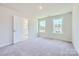 Bright and airy bedroom with carpet floors and views into the bathroom at 3886 Horsham St, Indian Land, SC 29707