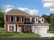 Two-story brick home with black shutters, a manicured lawn, and an attached two-car garage at 3886 Horsham St, Indian Land, SC 29707