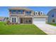 Inviting two-story home showcasing a brick facade, well-manicured lawn, and a two-car garage at 3886 Horsham St, Indian Land, SC 29707