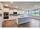 Modern kitchen with white cabinets, stainless steel appliances, and a large center island at 3886 Horsham St, Indian Land, SC 29707
