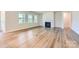 Bright living room with hardwood floors, a fireplace, and large windows offering natural light at 3886 Horsham St, Indian Land, SC 29707