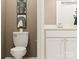 A clean, minimalist bathroom features a modern toilet, sink, vanity and decorative art at 4104 Skyboat Cir, Fort Mill, SC 29715