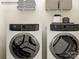 Well-equipped laundry room with modern washer and dryer units, plus storage shelves at 4104 Skyboat Cir, Fort Mill, SC 29715