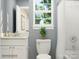 A modern bathroom with a single sink vanity, toilet, and a shower with a curtain at 4171 Skyboat Cir, Fort Mill, SC 29715