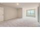 Bedroom with carpet, a door, and a window with a view of the neighborhood at 4171 Skyboat Cir, Fort Mill, SC 29715