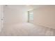 Bedroom with carpet, a door, and a window with a view of the neighborhood at 4171 Skyboat Cir, Fort Mill, SC 29715