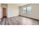 Bright bedroom with hardwood floors, a closet, and two windows at 4171 Skyboat Cir, Fort Mill, SC 29715