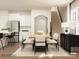Open-concept dining room with a modern table set, adjacent to a kitchen and stairway at 4171 Skyboat Cir, Fort Mill, SC 29715