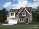New two-story home with stone accents, attached garage and beautiful yard with lush landscaping and driveway at 4171 Skyboat Cir, Fort Mill, SC 29715