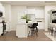 Bright kitchen featuring white cabinets, a central island with seating, and stainless steel appliances at 4171 Skyboat Cir, Fort Mill, SC 29715