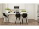 Contemporary kitchen with stylish black bar stools, white countertops, and stainless steel appliances at 4171 Skyboat Cir, Fort Mill, SC 29715