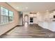 Open-concept living area featuring hardwood floors, a kitchen, and a staircase at 4171 Skyboat Cir, Fort Mill, SC 29715