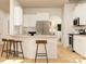 Open kitchen featuring white cabinets, stainless steel appliances, and a breakfast bar with stools at 4203 Skyboat Cir, Fort Mill, SC 29715