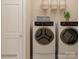 Modern laundry room showcasing a front-load washer and dryer set with storage at 4203 Skyboat Cir, Fort Mill, SC 29715
