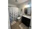 Clean bathroom features a shower with a floral curtain and functional vanity area at 52 Restful Ln, Hickory, NC 28601
