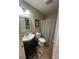Cozy bathroom with tiled floors, patterned shower curtain and decorative mirror at 52 Restful Ln, Hickory, NC 28601