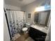 The bathroom has a floral shower curtain, granite counter, and wood-framed mirror at 52 Restful Ln, Hickory, NC 28601