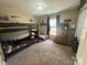 Cozy bedroom featuring bunk beds, carpeted floors, and natural light from the window at 52 Restful Ln, Hickory, NC 28601