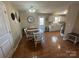 The dining area has a hardwood floor with a round table and views into the kitchen at 52 Restful Ln, Hickory, NC 28601