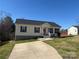 Charming single-story home featuring a well-manicured lawn and a concrete driveway on a sunny day at 52 Restful Ln, Hickory, NC 28601