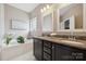 Elegant bathroom boasts double vanity with granite countertops, soaking tub, and decorative plants at 5386 Josephine Sw Ln, Concord, NC 28027