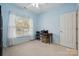 Light-filled bedroom features neutral walls, a window, and desk workspace at 5386 Josephine Sw Ln, Concord, NC 28027