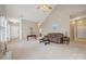 Spacious living room with a vaulted ceiling, plush carpeting, and ample natural light at 5386 Josephine Sw Ln, Concord, NC 28027