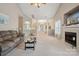 Large living area featuring a fireplace, columns, and open access to dining and kitchen at 5386 Josephine Sw Ln, Concord, NC 28027