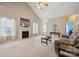 Bright living room with a fireplace, large windows, and a neutral color palette at 5386 Josephine Sw Ln, Concord, NC 28027