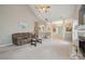 Open-concept living room with high ceilings, a fireplace, and neutral carpeting at 5386 Josephine Sw Ln, Concord, NC 28027