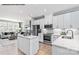 Modern kitchen features white cabinets, stainless steel appliances, and a center island at 6029 Fonsac Ln # 2008C, Charlotte, NC 28217