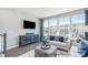 Comfortable living room featuring large windows and chic furnishings and decor at 6029 Fonsac Ln # 2008C, Charlotte, NC 28217