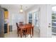 Cozy dining area with a wooden table, chairs, and a bright bay window at 611 Chase Brook Dr, Rock Hill, SC 29732