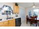Bright kitchen featuring a double sink, a dishwasher, a dining table, and a large window at 611 Chase Brook Dr, Rock Hill, SC 29732