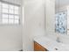 Bright bathroom featuring a single sink vanity and a window with white blinds at 6821 Parkers Crossing Dr, Charlotte, NC 28215