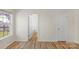 Bedroom with light-colored walls, wood floors, and a large window at 6821 Parkers Crossing Dr, Charlotte, NC 28215