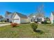 Well-kept single-Gathering home boasts an attached garage, manicured lawn, and inviting curb appeal at 6821 Parkers Crossing Dr, Charlotte, NC 28215