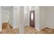 Inviting foyer with wood flooring, decorative front door, and natural light at 6821 Parkers Crossing Dr, Charlotte, NC 28215