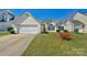 Charming single-Gathering home with a well-maintained lawn, attached garage, and inviting curb appeal at 6821 Parkers Crossing Dr, Charlotte, NC 28215