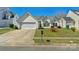 Inviting single-Gathering home with lush lawn, attached garage, and charming architectural details at 6821 Parkers Crossing Dr, Charlotte, NC 28215